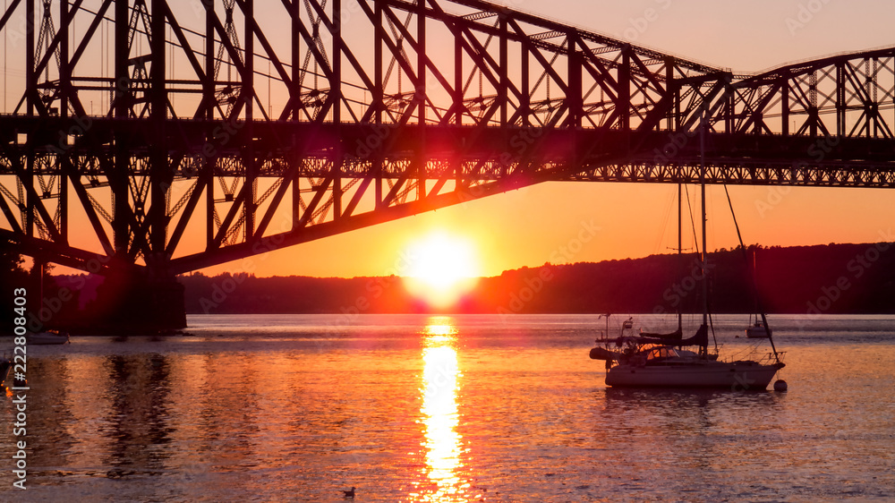 Canada - Sunset reflection over the water of a small marina near the old bridge between Levis and Quebec City. Canada - Sunset reflection over the water of a small marina near the old bridge between Levis and Quebec City.
