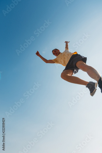 Parkour guy jump over obstacles outdoors