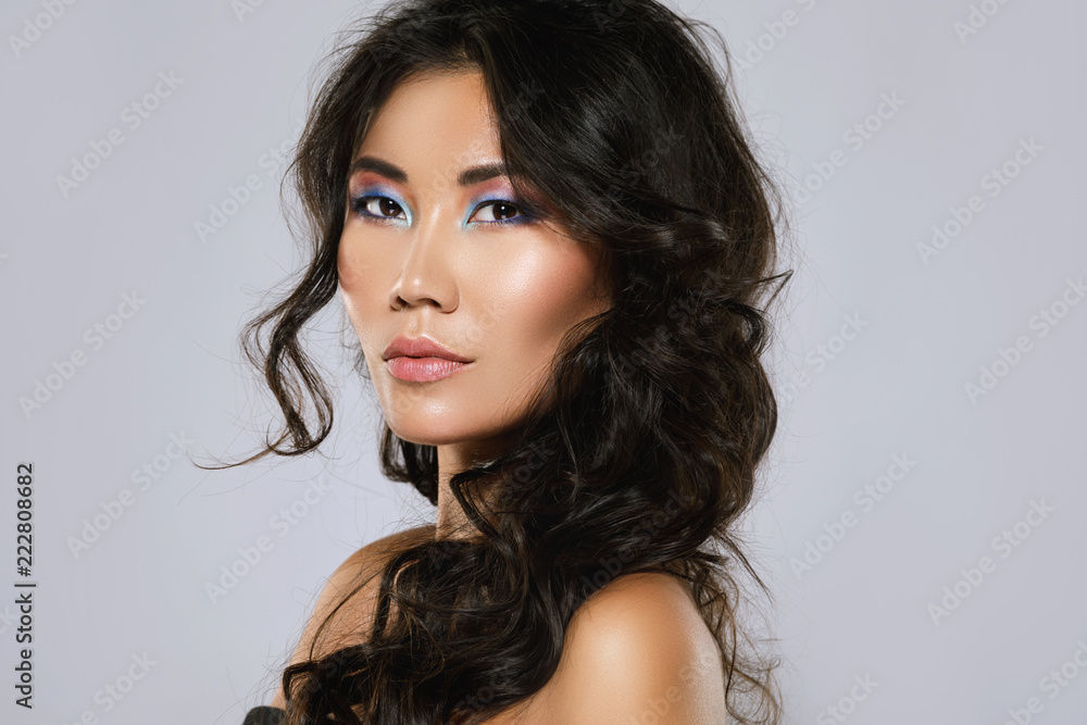 Young asian woman with a beautiful curly hair and make-up - obrazy, fototapety, plakaty 