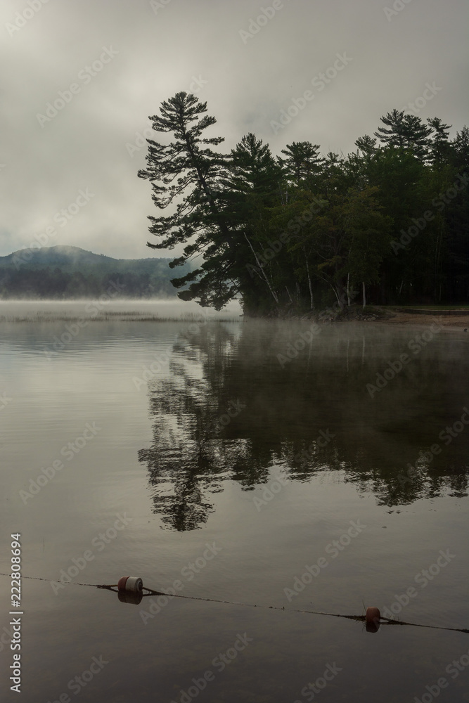 Fototapeta premium Foggy morning view of Webb Lake from Mt. Blue State Park campground
