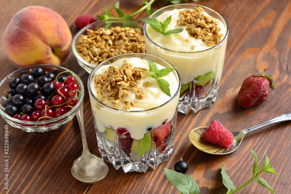 Dessert with fresh berries, granola and custard in glasses Dessert with fresh berries, granola and custard in glasses
