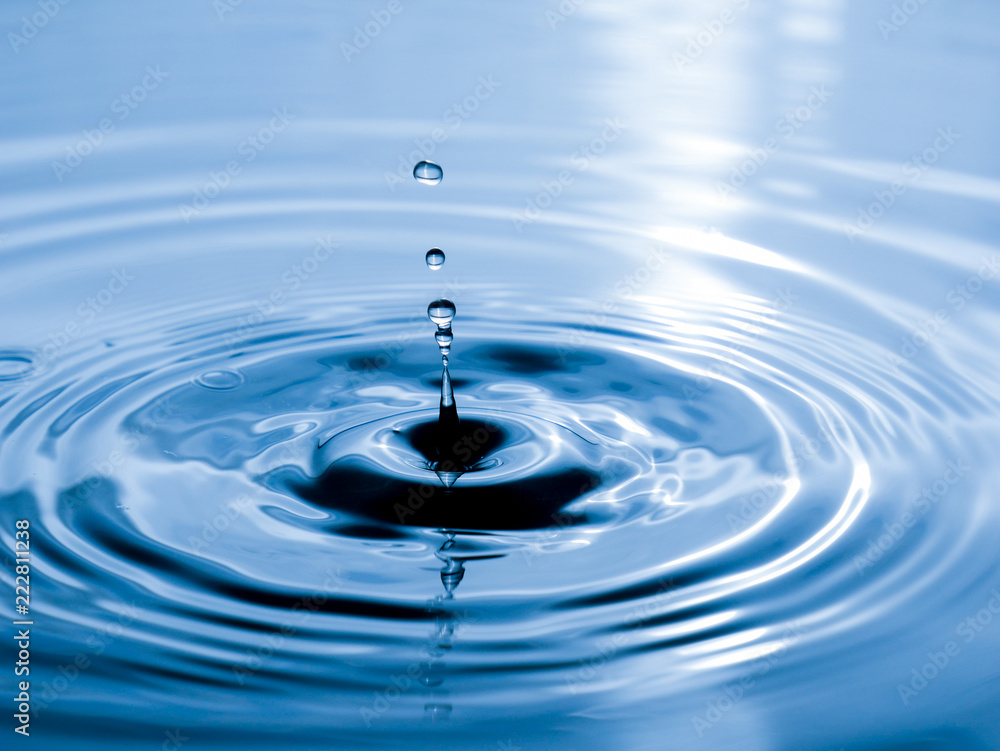 close up drop of water on blue background close up drop of water on blue background