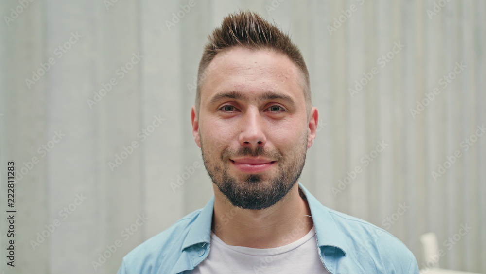 A man with a beard smiling against a blurry white background. Close-up shot. Soft focus A man with a beard smiling against a blurry white background. Close-up shot. Soft focus