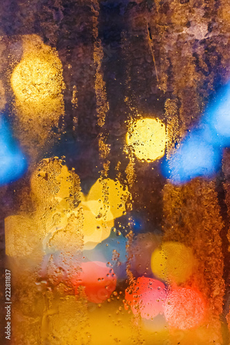Rain drops on window with bokeh. Vertical composition