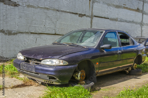 Unattended abandoned car in the woods on the nature