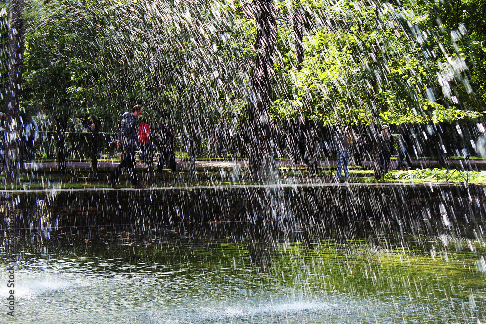 Pouring rain, walking people through the drops Pouring rain, walking people through the drops