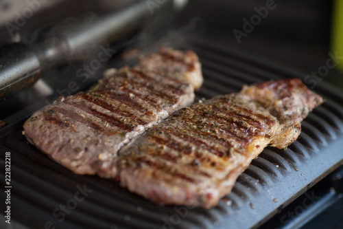 Meat on an electric grill. Home cooking. Healthy barbecue. Catering to friends. Electric grilling