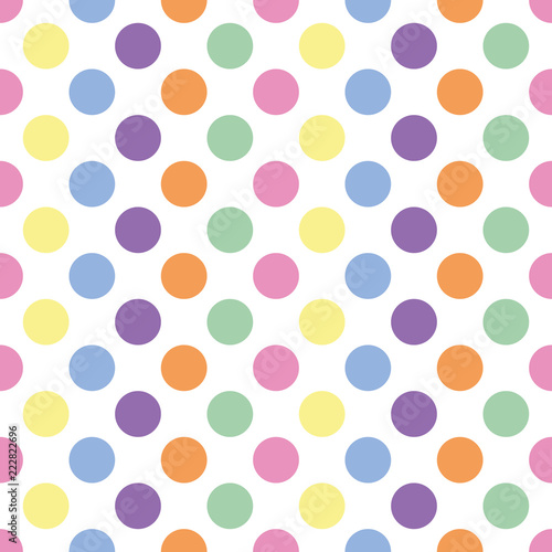 seamless background of pastel colored polka dots on white