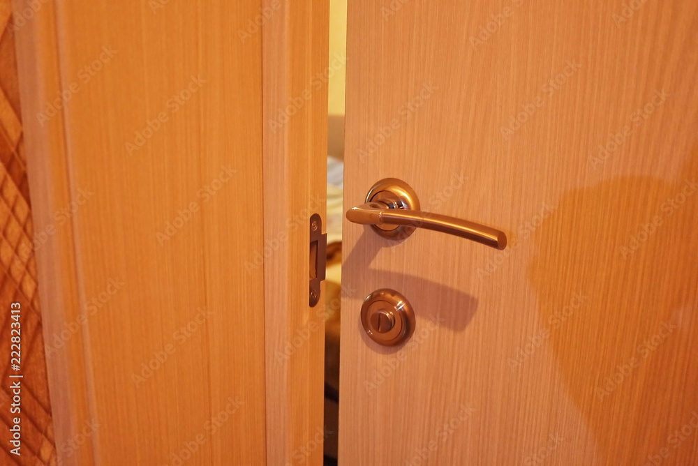 Door handle with lock on the new door in the room. Close-up, made of metal Door handle with lock on the new door in the room. Close-up, made of metal
