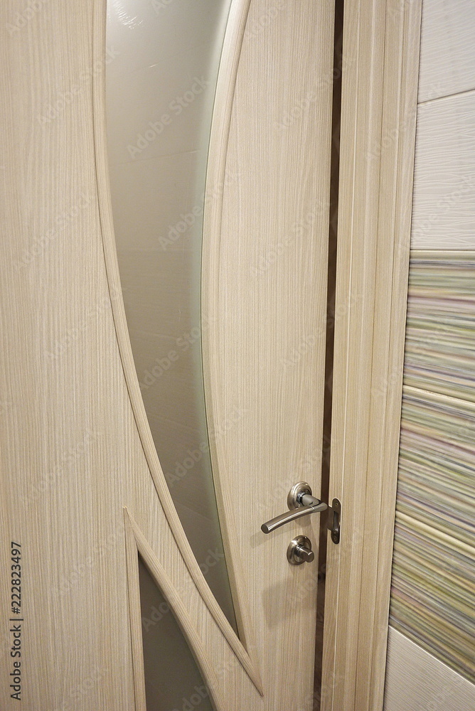 The interior of a room installed with a new interior. door.The installed door harmoniously complements the interior of the room, bathroom or toilet The interior of a room installed with a new interior. door.The installed door harmoniously complements the interior of the room, bathroom or toilet