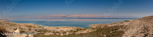 Panoramic landscape of Dead Sea and Jordan mountains in middle day. Israelian border coastline