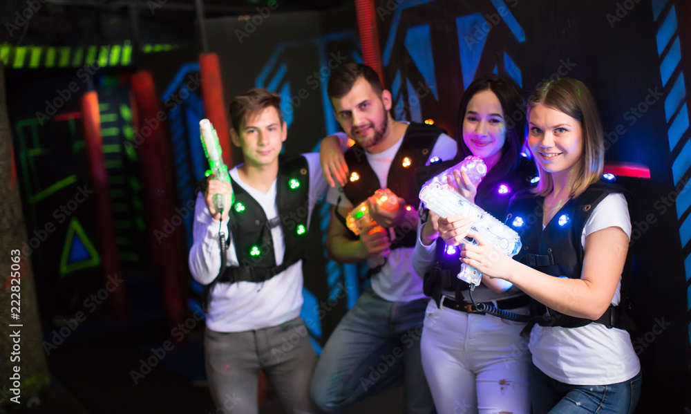 Fototapeta premium Young people with laser guns on lasertag arena
