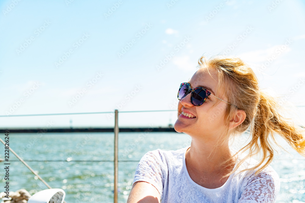 Beautiful and joyful girls, smiling friends, on the deck of a yacht