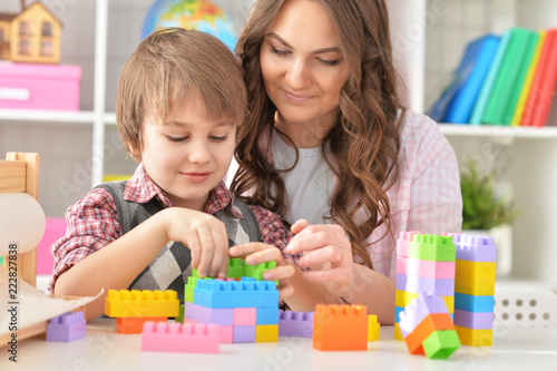 Woman and boy playing blocks game together