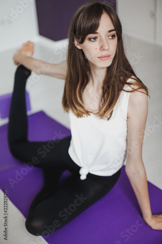 Young slender girl doing yoga