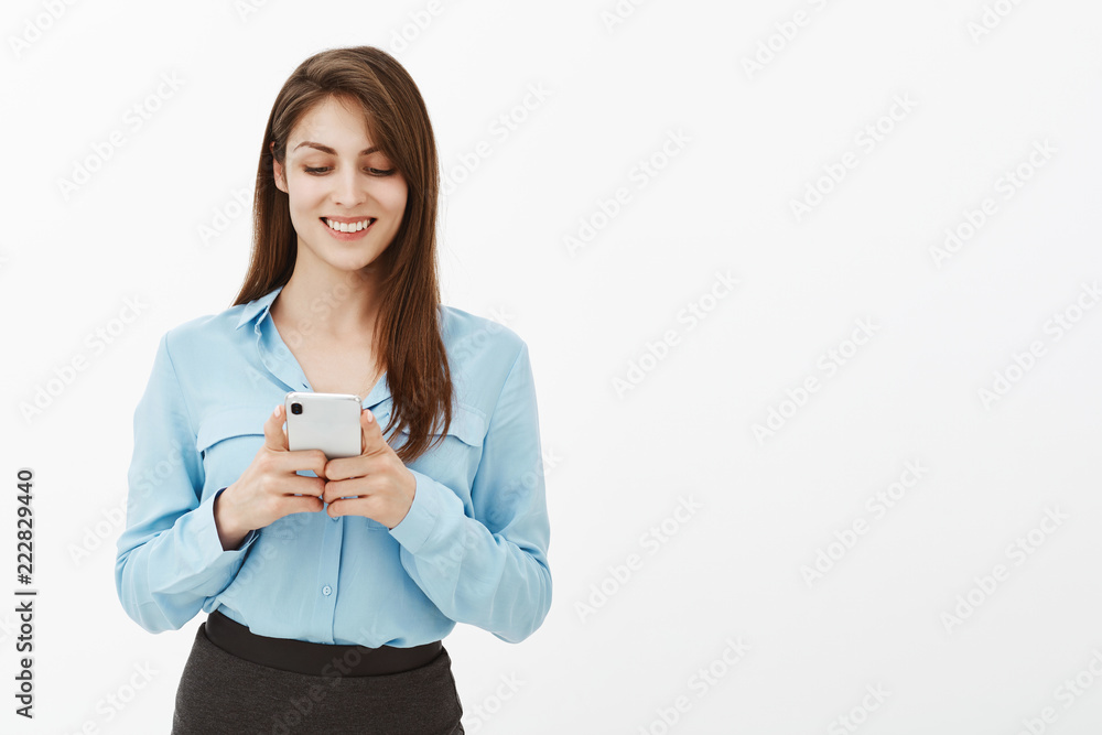 Wait sec, need send message to boyfriend. Attractive happy european female in blue blouse, playing app in bran new smartphone, gazing at screen while enjoying spending free time during lunch Wait sec, need send message to boyfriend. Attractive happy european female in blue blouse, playing app in bran new smartphone, gazing at screen while enjoying spending free time during lunch