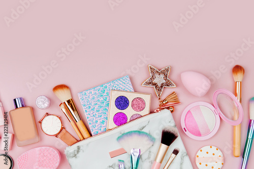 Female cosmetics collage with lipstick, brush and other accessories on pink background. Flat lay, top view.