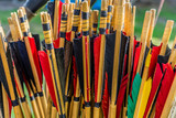 Colorful shafts of wooden arrows with real bird feathers for shooting with a bow