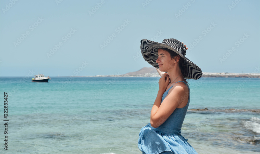Girl smiling and looking at the ocean. Back View. Photo with added film and grain filter Girl smiling and looking at the ocean. Back View. Photo with added film and grain filter