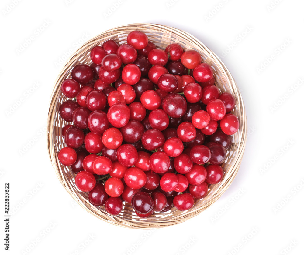 bright ripe fresh cherries in a basket on a white isolated background. top view bright ripe fresh cherries in a basket on a white isolated background. top view
