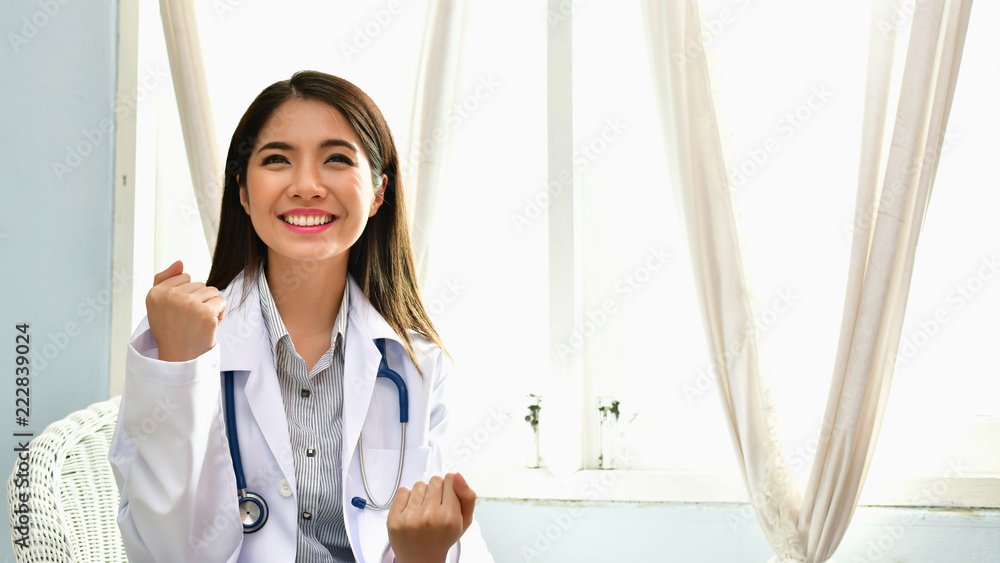 Smiling doctor posing in the office, She is wearing a stethoscope, medical staff on the hospital background Smiling doctor posing in the office, She is wearing a stethoscope, medical staff on the hospital background
