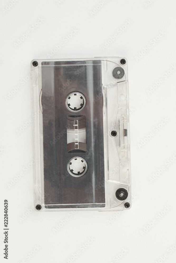 Old cassette tape on white background. Retro audio cassette isolated on white, vertical image. Vintage musical technology. Old cassette tape on white background. Retro audio cassette isolated on white, vertical image. Vintage musical technology.