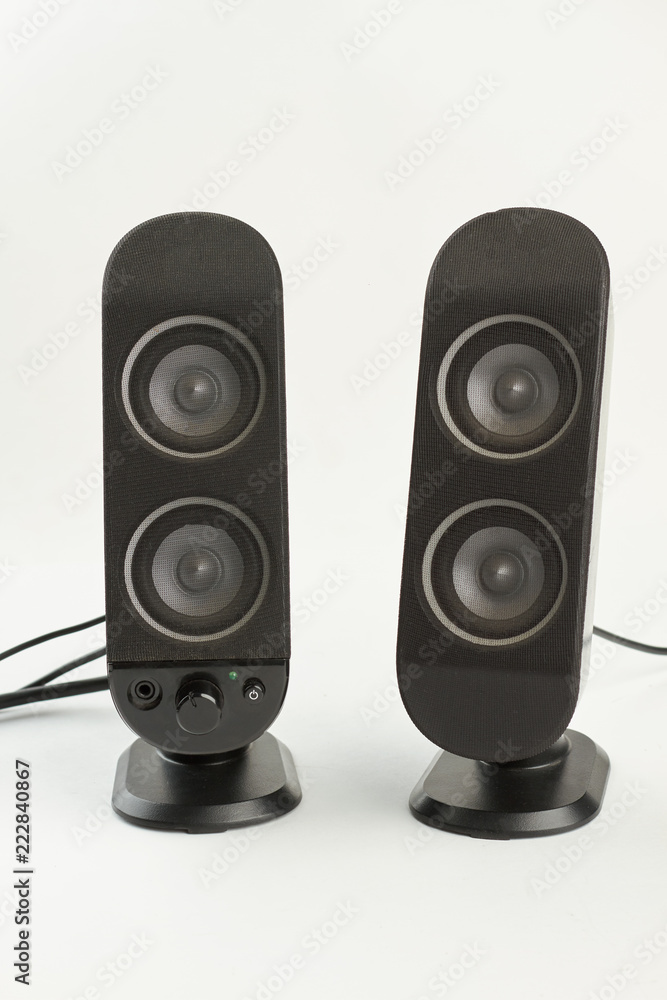 Two sound columns on white background. Pair of professional sound speakers isolated on white. Modern audio technology. Two sound columns on white background. Pair of professional sound speakers isolated on white. Modern audio technology.