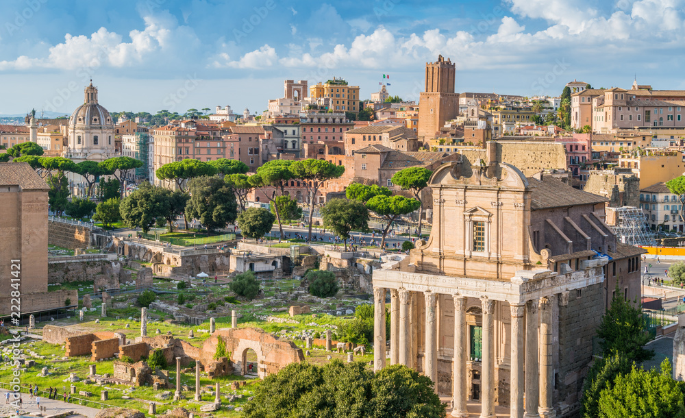 Scenic sight in the Roman Forum, with the Temple of Antonino and Faustina, the Tower of the Militia and the Trajan's Market. Rome, Italy.