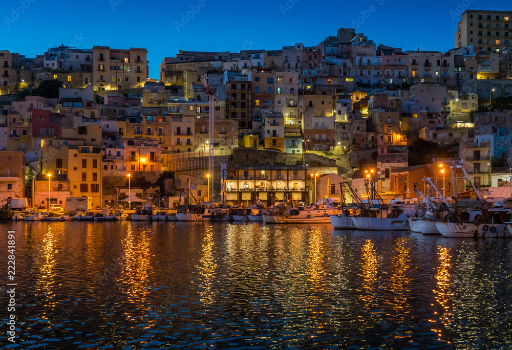The picturesque city of Sciacca in the evening overlooking its harbour. Province of Agrigento, Sicily.