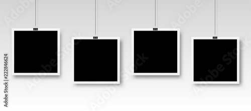 Four photo frames hanging on a clip. Vector