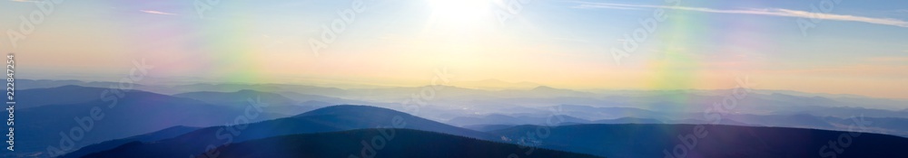 Panoramic morning view from the peak of Snezka, the highest mountain of czech republic in the karkonosze national park, looking to the Svorova Mountain, showing the border between to Poland