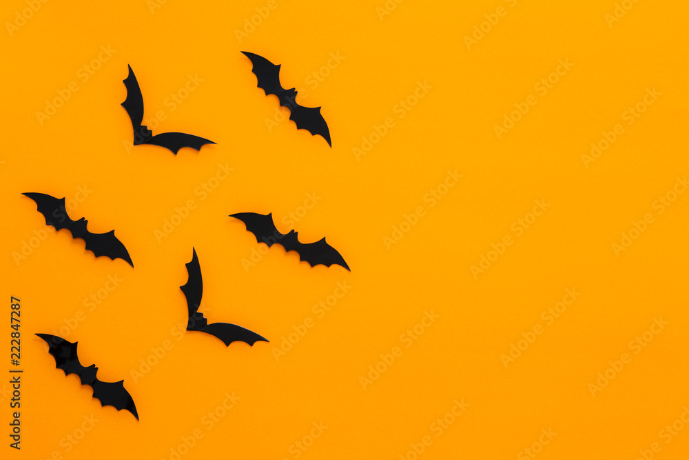 Bats with an orange background. Halloween concept. Bats with an orange background. Halloween concept.