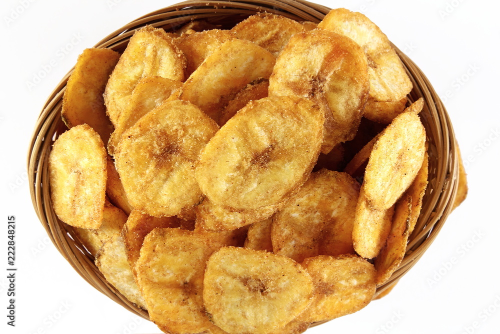 spicy salty banana chips or wafers with herbs masala traditional indian gujarati snack isolated on a white background spicy salty banana chips or wafers with herbs masala traditional indian gujarati snack isolated on a white background