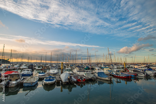 Moored boats in English coastal marina at sunset