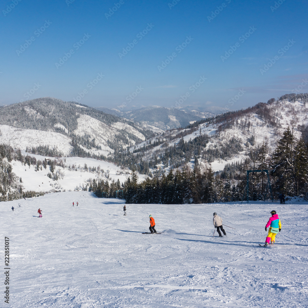 Skiers on the mountain slope on a background of mountains