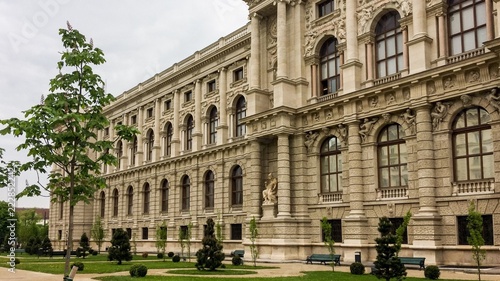 blooming chestnut near a beautiful building, beautiful building, cloudy weather, young flowering trees photo