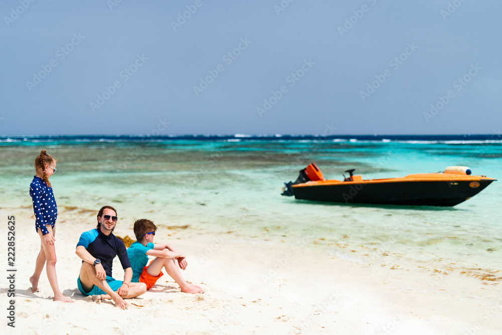 Father with kids at beach