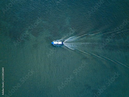 Aerial top view of single tourist boat in a river near Guayaquil city.