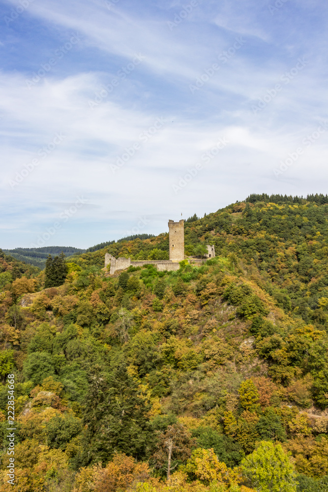 Colored autumn view to the ruins of Oberburg or Upper Castle in Manderscheid, Germany
