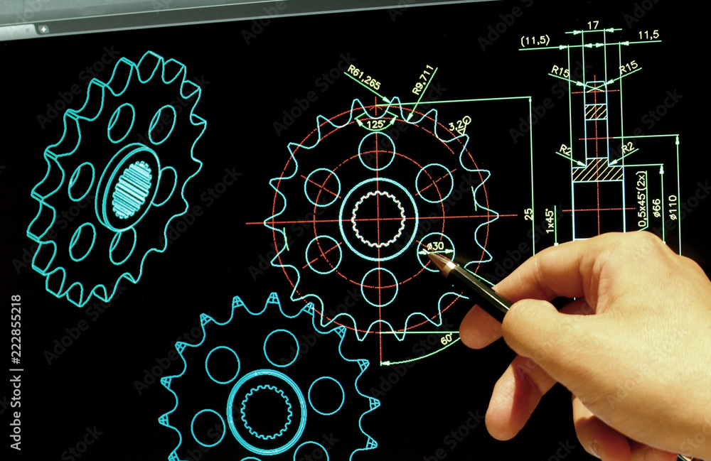 engineer working on computer at mechanical gear design cad blueprints