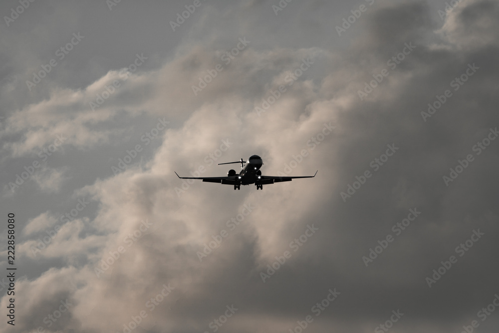 High contrast of jet plane against clouds High contrast of jet plane against clouds