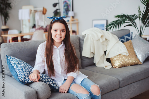 Fényképezés happy 10 years old kid or preteen girl relaxing at home