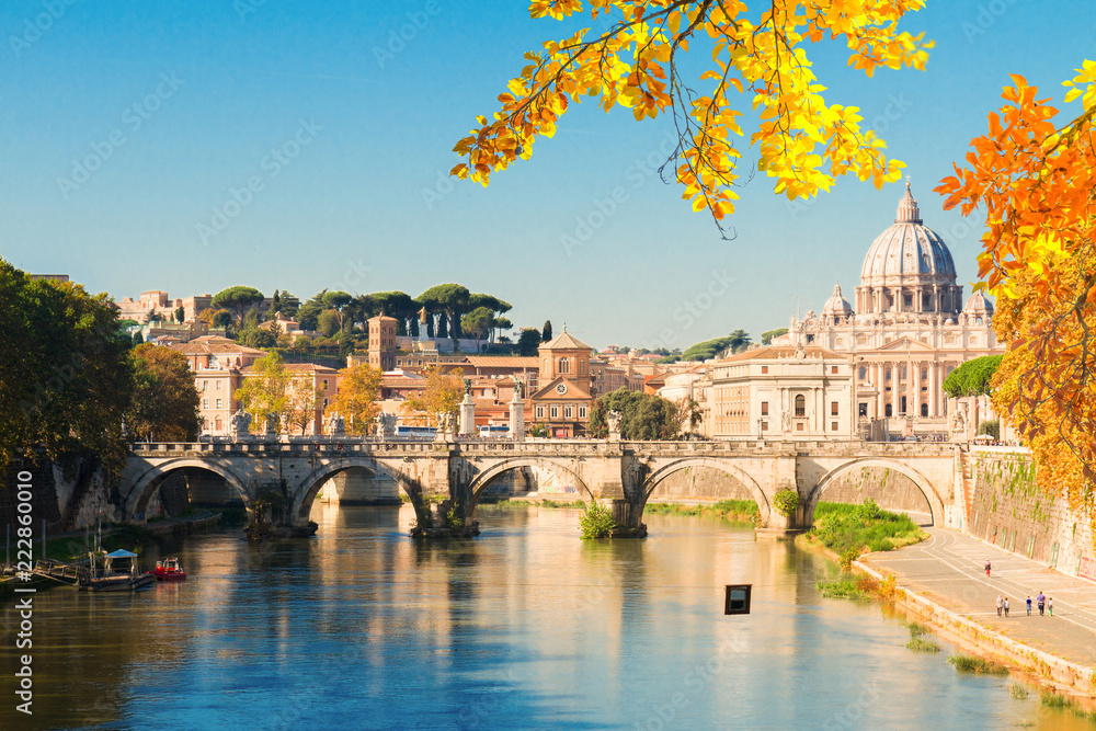 St. Peter's cathedral over bridge and river water at autumn day Rome, Italy