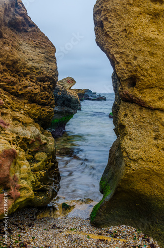 The photo of the stone on the beach on the long exposure