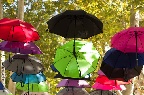 Landscape view of colorful umbrellas hanging on the trees in the park. Zagreb  Croatia. Abstract background.