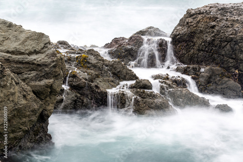 Long exposure of surf washed rocks on a foggy day
