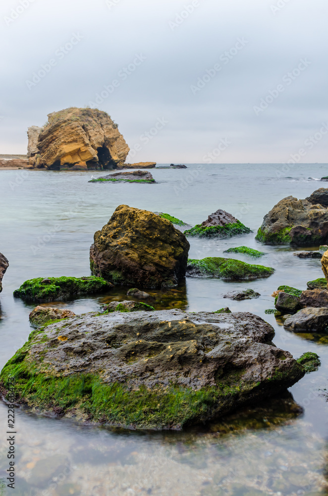 The photo of the stone on the beach on the long exposure The photo of the stone on the beach on the long exposure