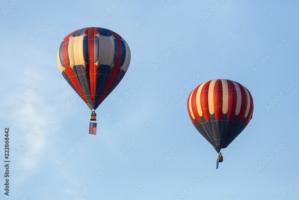 American flag and Nevada state flag flying with hot air balloons American flag and Nevada state flag flying with hot air balloons