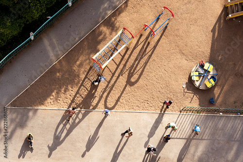 The guys in the yard playing on sunny day . Clearly visible the shadow people.