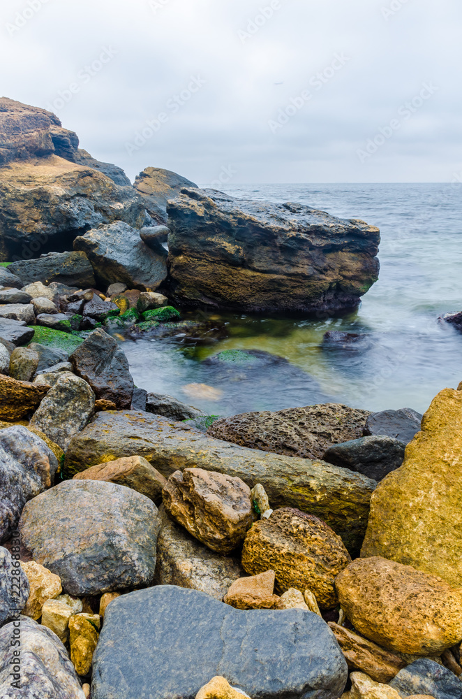 The photo of the stone on the beach on the long exposure